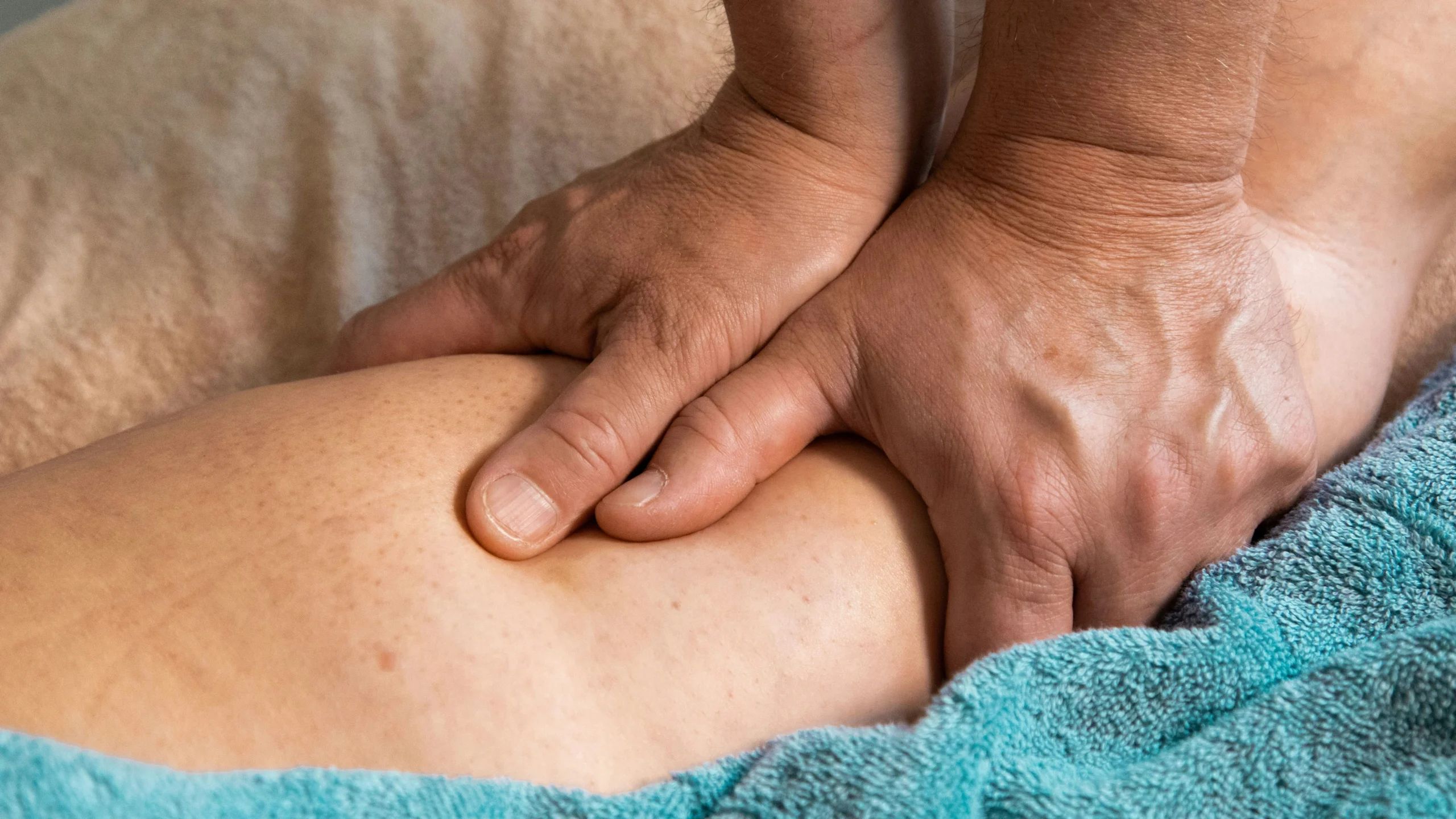 Physio therapist working on leg Sports therapist helping with leg injury